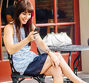 Woman sitting outside on cellphone