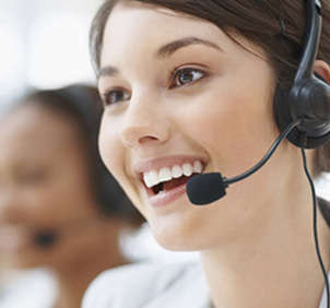 Smiling female telemarketer on call