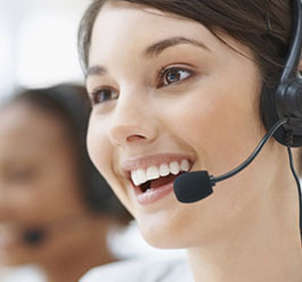 Smiling female telemarketer on call